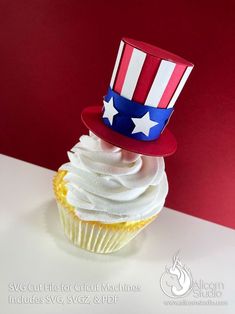 a cupcake with white frosting and an american flag hat on top