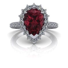 a heart shaped ruby and diamond ring with white diamonds on the sides, set in 18k white gold