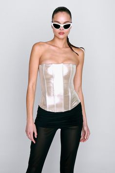 It's always Libra season. Introducing our Libra Corset in Metallic. The strapless Libra is a bit longer, offering more body hugging per square inch. She's perfect for showing off. Designed for a tight fit, true to size. Designed for a tight fit, true to size. Please refer to the flat lay image for product accuracy. Fitted Bandeau Corset With Boned Bodice, Fitted Bandeau Corset For Night Out, Strapless Corset With Built-in Bra For Club, Fitted Tube Top With Built-in Bra For Night Out, Evening Bandeau Fitted Corset, Fitted Bandeau Corset For Evening, Strapless Fitted Corset For Night Out, Fitted Bandeau Tube Top With Boning, Chic Fitted Bandeau Corset