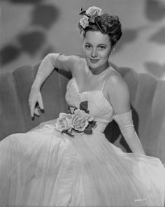 a black and white photo of a woman in a dress