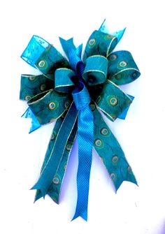 a blue bow with peacock feathers on it