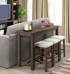 a living room filled with furniture and a flat screen tv sitting on top of a wooden table