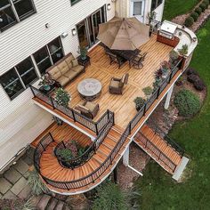 an aerial view of a deck with patio furniture and umbrellas on the top floor