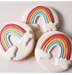 three decorated cookies with rainbows and stars on them