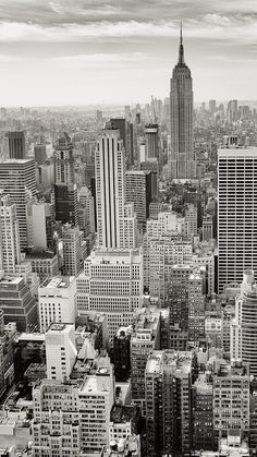 black and white photograph of city buildings in new york, ny with the empire building