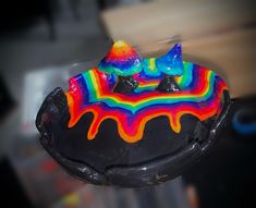 a cake with rainbow icing on top of it