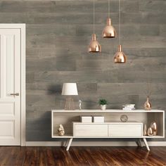 an empty room with wooden floors and wallpaper, including a white console table in the center