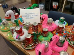 a table topped with lots of bottles and flamingo shaped drinks on top of it