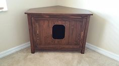 a dog house made out of wood in the corner of a room