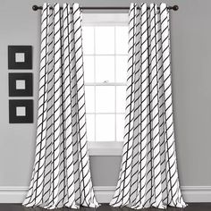 black and white curtains hanging in front of a window