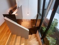 an aerial view of a house with wood floors and stairs, taken from the top floor