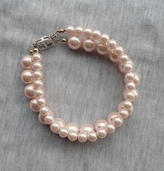 WARM PROMPT: The correct measurement of the length of the bracelet is:the length of the wrist +0.5-1 inch = the length of the bracelet. I make the 2 Strands Pearl bracelet with 6mm and 10mm light pink glass pearls, The bracelet lengh is 8 inches. It is nice for your wedding. The picture color is light pink. Can choose other colors are:ivory,white,light pink,Black, red, teal, gray, dark gray, turquoise,green and navy blue. If you need the other lengh or size ,Please feel free contact me.Thank you Elegant Pink Rosary Bracelet For Wedding, Elegant Pink Wedding Rosary Bracelet, Pink Pearl Drop Bracelet For Wedding, Pearl Bridesmaid Jewelry, Pearl Bracelet Wedding, Pearl Jewelry Wedding, Bracelet Wedding, Jewelry Bridesmaid, Jewelry Pearl