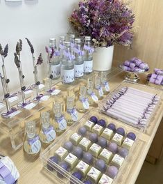 a table filled with lots of purple and white treats