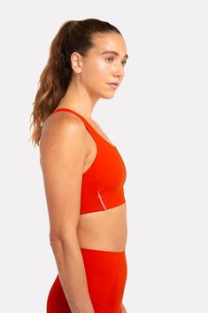 Our ALRN Crop Bra is made from post consumer waste products ( including fishing nets and carpets) and is sustainably produced in a method that significantly reduces water usage. This fabric offers excellent compression, coupled with stretch and breathability for the perfect amount of support without constriction. A clean finish neckline, armhole and under-bust ensures maximum comfort, even on your longest runs. Functional Orange Sports Bra For Training, Micro-elastic Recycled Polyester Sports Bra For Gym, Functional Orange Sports Bra For Workout, Lightweight Functional Activewear For Gym, Functional Breathable Orange Activewear, Functional Orange Breathable Activewear, Compressive Seamless Sports Bra In Recycled Polyester, Orange Fitted Functional Sports Bra, Fitted Orange Functional Sports Bra