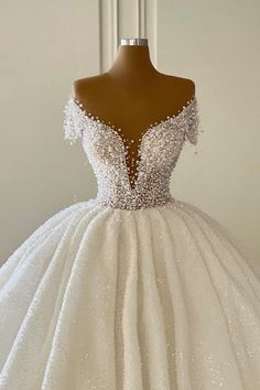 a white wedding dress on a mannequin dummy with beading and sequins