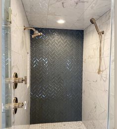 a walk in shower sitting inside of a bathroom next to a wall mounted faucet