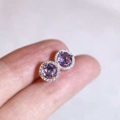 "These stylish earrings have a stunning bright color and the Amethyst is surrounded by a halo of shimmering diamonds. Perfect as a gift for yourself, your girlfriend or wife, or your mother. Features * Made to Order. * Metal: 925 Sterling Silver * Custom Color: Silver, Gold, Rose Gold * Main Stone: Amethyst, 5mm dia Round Shape, 2pcs * Side Stone: Cubic Zirconia Amethyst Ring: * Halo Ring: https://etsy.me/32kkc68 * Bypassing: https://etsy.me/32u2NIF Be sure to hit \"favorite\" on the right so it Purple Jewelry With Halo Setting As Gift, Purple Amethyst Birthstone Earrings, Tanzanite Round Earrings As Gifts, Round Amethyst Gemstones With Halo Setting, Tanzanite Birthstone Earrings As Gift, Round Amethyst Gemstone Earrings, Tanzanite Birthstone Earrings For Gifts, Round Tanzanite Earrings For Gifts, Round Tanzanite Earrings Gift