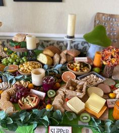 a table topped with lots of different types of cheese and crackers on top of it