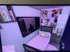 a flat screen tv mounted to the side of a wall next to a small bed