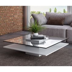 a glass coffee table sitting on top of a carpeted floor next to a couch