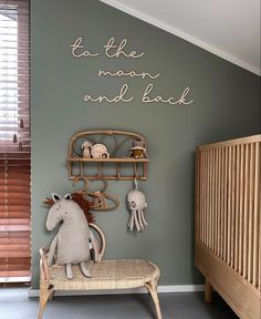 a baby's room with a rocking horse and toys on the shelf above it