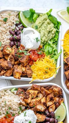 three trays filled with tacos, rice and beans next to lime wedges