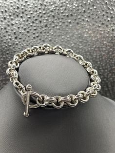 A classic design ladies Sterling Silver bracelet designed in round Cuban links.   Weight:  18.2 grams Length:  7" Our Price $189.00 Regularly Priced At $360.00 Please See Our Video Remember - If you're purchasing for yourself or a gift for a loved one, buy with confidence.  We Guarantee Everything We Sell!  SKU #B808 Cheap Nickel-free Sterling Silver Round Bracelet, Luxury Elegant Sterling Silver Bracelet With Clasp, Classic Jewelry Bracelet With Rolo Chain, Classic Bracelet Jewelry With Rolo Chain, Classic Charm Bracelet With Sterling Silver Clasp, Classic Rolo Chain Bracelets, Formal Rolo Chain Bracelet Jewelry, Classic Rolo Chain Link Bracelets, Classic Silver Bracelet With Rolo Chain