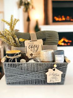 a wicker basket filled with various items on a table in front of a fireplace