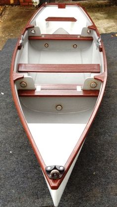 a small wooden boat sitting on the ground