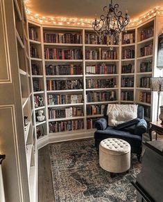 a living room filled with lots of bookshelves next to a couch and chair