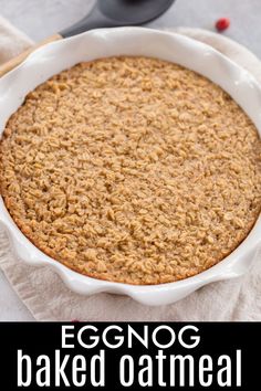 an eggnog baked oatmeal in a white dish with the words eggnog baked oatmeal above it