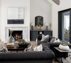 a living room filled with furniture and a fire place in the middle of a room