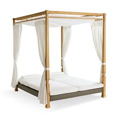 a canopy bed with white sheets and curtains on it's sides, against a white background