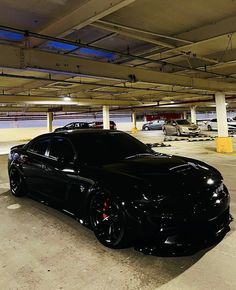 a black sports car parked in a parking garage