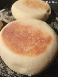 two round breads sitting on top of a frying pan