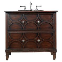 an antique style bathroom vanity with two sinks and wood accents on the front, in dark brown