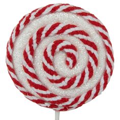 a red and white lollipop on a stick