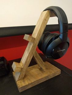 a pair of headphones sitting on top of a wooden stand