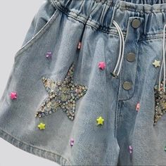 Introducing the 2023 Summer Collection the perfect balance between vintage nostalgia and trendy flair. Our Rhinestone Star Embellished Denim Shorts. Y2K Style will bring you back to the era of innocence and fun. Featuring a high-waist. baggy fit. rhinestone stars. buttons. and rubber closure. these shorts will make you feel like you've stepped into a time machine!Why These Shorts Will Make You Feel Like a Kid Again A Blast from the Past: Step back in time with the vintage Y2K style. featuring a Trendy Bottoms With Star Patch For Spring, Trendy Spring Bottoms With Star Patch, Summer Star Print Denim Jeans, Trendy Cotton Jean Shorts With Star Print, Cotton Jeans With Star Patch For Summer, Summer Denim Shorts With Star Print, Trendy Summer Jean Shorts With Star Print, Trendy Jean Shorts With Star Print For Summer, Casual Jean Shorts With Rhinestones