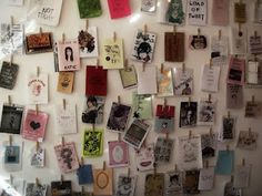 a refrigerator covered in lots of magnets and pictures on clothes pins with notes attached to them