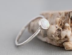 Want 20% off this item? Go here to claim your coupon code! https://pintody.com/pages/discounts This Textured Stack-able opal ring features a 5mm simulated opal gemstone. A perfect opal stacking ring for a slim look for stacking gemstone rings together for a dramatic look. Wear alone or stack with other silver stacking rings and bands. Add other gemstones for a mothers ring and birthstone options. The hammered texture gives the ring a shimmery look for your most dressed affair. A delicate ring wi Minimalist Opal Ring With Bezel Setting As Gift, Everyday Stackable Opal Ring, Handmade Minimalist Opal Promise Ring, Minimalist Handmade Opal Promise Ring, Minimalist Silver Stackable Opal Ring, Simple Adjustable Rings With Ethical Gemstones, Adjustable Stackable Moonstone Promise Ring, Minimalist Stackable Rings With Round Stones As Gift, Minimalist Stackable Rings With Round Stone For Gift