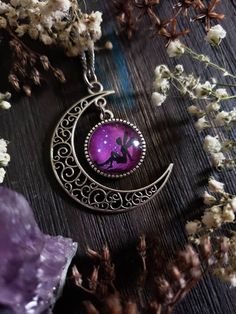 "Boho Fairy moon necklace with an adorable fairy sitting on a beautiful purple starry night background. You can choose your finish of Bronze or Silver. ➳ Moon measures approximately 2\"x2\". ➳ Reference photo chart to determine the length that suits you. ➳ Bronze chain is lead free metal alloy. ➳ Silver chain is stainless steel and suitable for those with allergies to certain metals. ̩̩͙✩*̩̩͙*˚＊ ̩̩͙✩*̩̩͙*˚＊ ̩̩͙✩*̩̩͙*˚＊ ̩̩͙✩*̩̩͙*˚＊ ̩̩͙✩*̩̩͙ 🌙 The Lunarly Lotus is a new shop but I have been a sel Fantasy Moon Shaped Jewelry Gift, Handmade Purple Fantasy Necklaces, Handmade Purple Fantasy Necklace, Whimsical Purple Jewelry For Gifts, Whimsical Purple Necklace For Gifts, Whimsical Purple Necklace For Gift, Purple Fantasy Necklace For Gift, Purple Fairycore Jewelry For Gifts, Fairycore Purple Jewelry As A Gift