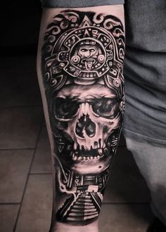 a man's leg with a skull and pyramid tattoo on it