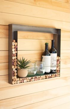 a wooden shelf with wine bottles and glasses on it