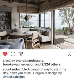 a living room filled with furniture and large windows