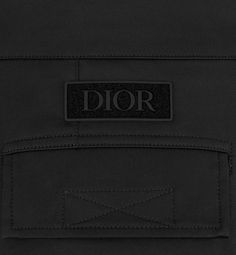 The cargo pants are crafted in black stretch cotton gabardine. The utilitarian silhouette features large flap pockets, ankle snaps and a Dior signature soft patch in the back. The casual cut makes them an ideal match for any of the season's T-shirts or hooded sweatshirts.. Denim Swimsuit, Dior Star, Blanket Poncho, Icon Shoes, Dior Book Tote, Short Denim, Short T Shirt, Star Shoes, Wallet Pouch