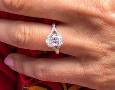 a woman's hand with a diamond ring on it