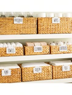 the shelves have baskets with labels on them that read towels, toiletries and wipes