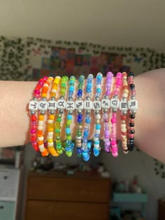 a woman's arm with several bracelets on it