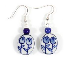 A true collector's item, these hand-painted blue and white porcelain beads are hard to find!  They are topped with a cobalt blue ceramic bead and are available with either sterling silver ear wires or stainless steel (silver-plated and very tarnish-resistant). See our matching bracelets and necklaces.  Made at Style ARThouse in Maryland from imported beads. Would make a wonderful gift!  Comes nicely packaged in a Style ARThouse gift box with little card telling title, materials, and care instruc Blue Delft, Dutch Blue, Painted Beads, Popular Earrings, Handmade Clay Jewelry, Porcelain Earrings, Clay Jewelry Diy, Painted Porcelain, Floral Jewellery